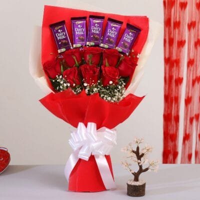 Bunch of red roses with chocolates
